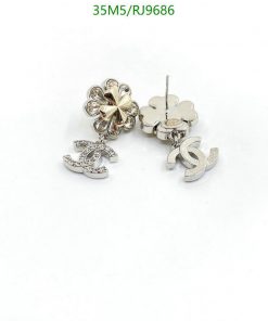 Silver flower and letter 'S' earrings.