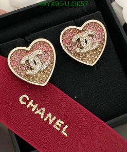 Heart-shaped earrings with jewels in a box.