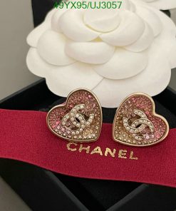 Heart-shaped earrings with gemstones on branded ribbon.