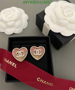 Chanel heart-shaped earrings and camellia flowers on display.