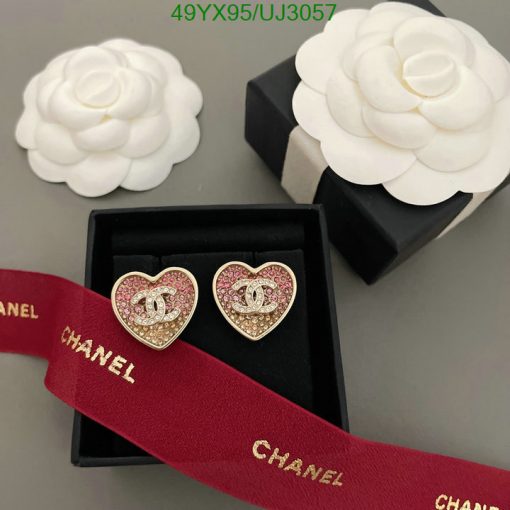 Chanel heart-shaped earrings and camellia flowers on display.