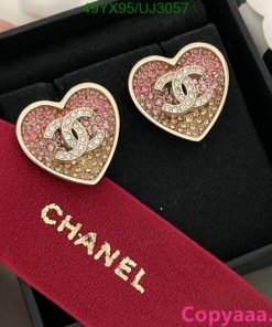 Heart-shaped logo earrings with pink crystals in box.