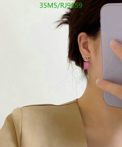 Person with earring talking on purple phone.