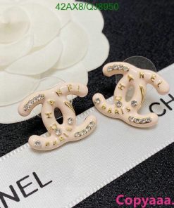 Designer logo earrings with rhinestones on label.