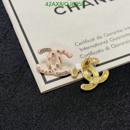 Designer earrings with gems on certification card.