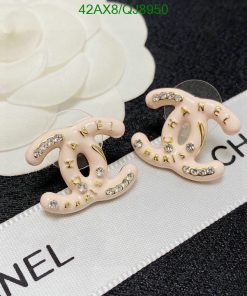 Designer logo earrings with rhinestone accents on label.