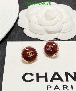 Designer brand earrings and camellia flower decoration.
