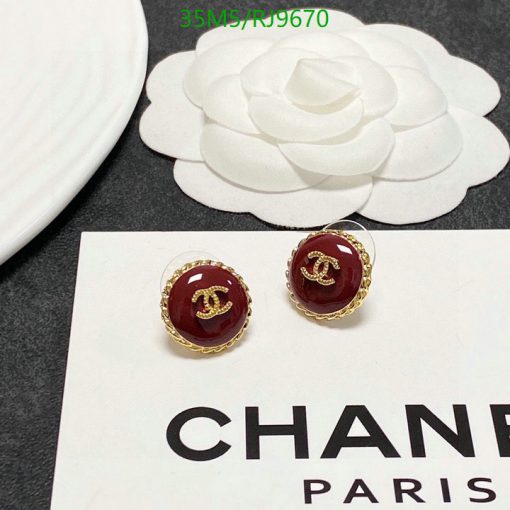 Designer brand earrings and camellia flower decoration.