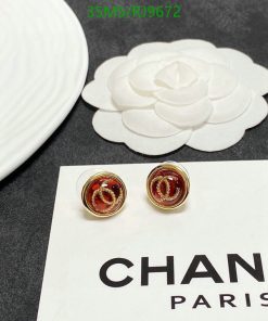 Chanel earrings and logo with a white camellia-shaped decoration.