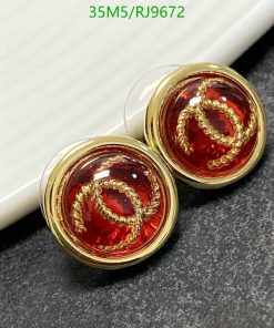 Gold-rimmed red cufflinks on display.