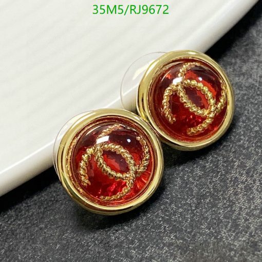 Gold-rimmed red cufflinks on display.