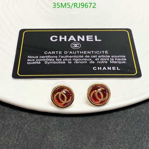 Chanel authenticity card and logo earrings on white surface.