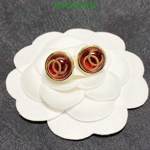 Gold-tone logo stud earrings on white display.