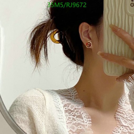 Woman with phone reflecting in mirror.