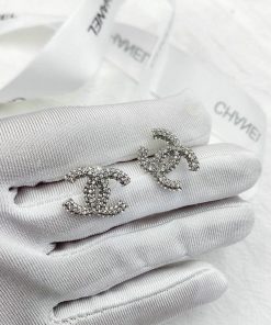 Silver brooches on gloves, luxury fashion accessory.