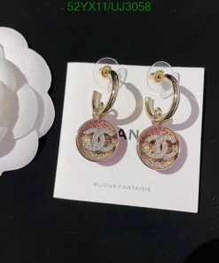 Designer logo earrings with rhinestones on display.