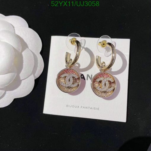 Designer logo earrings with rhinestones on display.