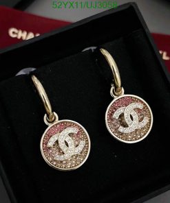 Gold hoop earrings with pink crystals in box.