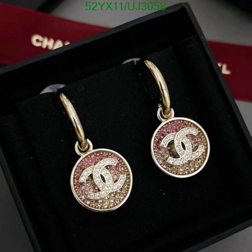 Gold hoop earrings with pink crystals in box.