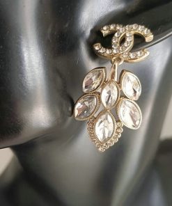 Elegant crystal drop earring on dark mannequin.