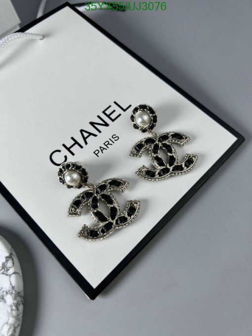 Chanel pearl earrings on brand display card.