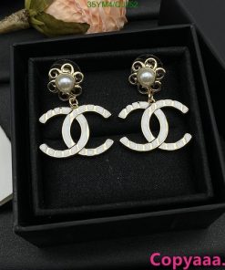 Elegant pearl designer logo earrings in box.