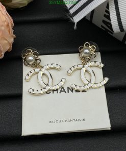 Pearl-studded Chanel logo earrings on display.