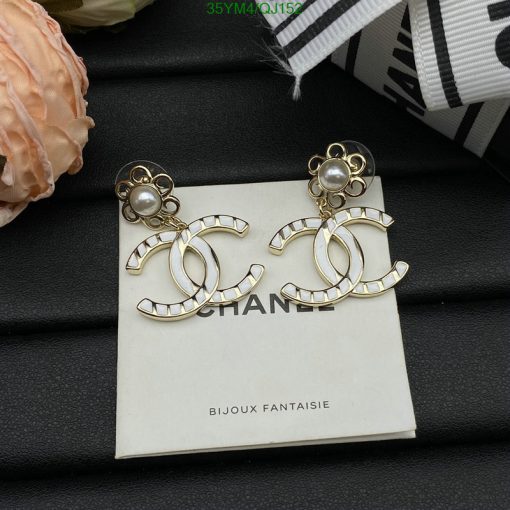 Pearl-studded Chanel logo earrings on display.