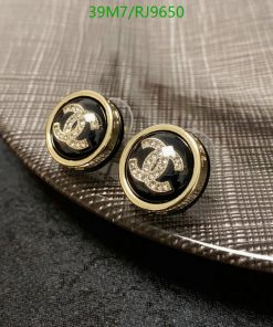 Designer logo cufflinks on textured fabric.