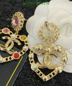 Gold-tone designer earrings with gems and pearls.