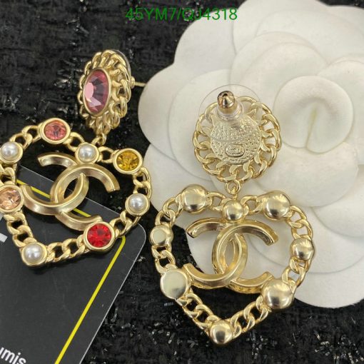 Gold-tone designer earrings with gems and pearls.