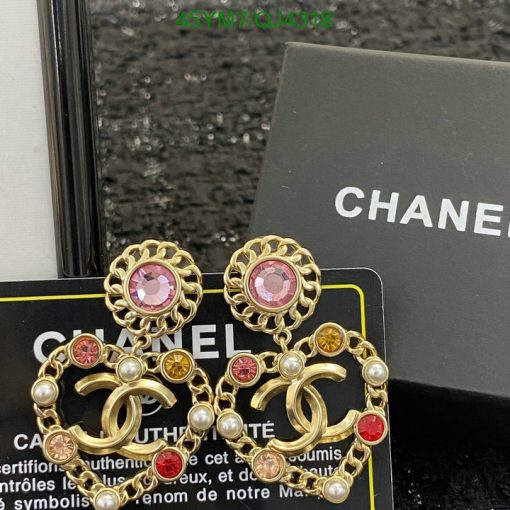 Chanel gold-tone earrings with jewels and pearls on box.