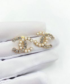 Pearl and rhinestone hair clips on fabric.