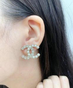 Woman wearing pearl-embellished earring.