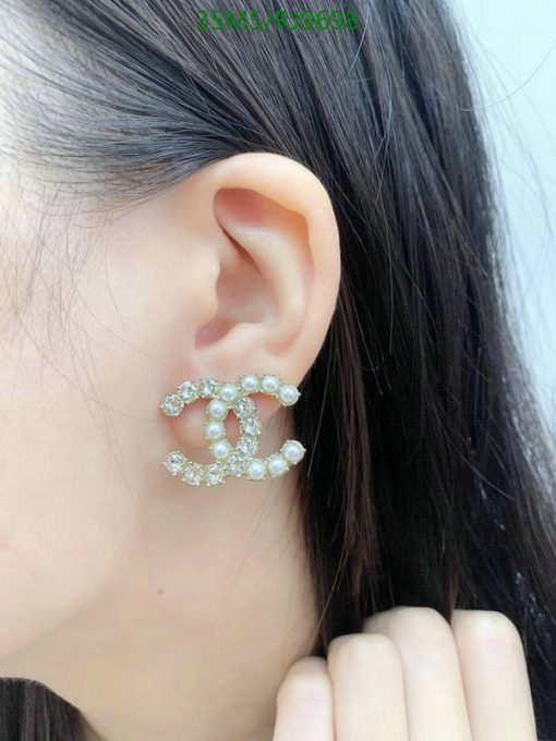 Woman wearing pearl-embellished earring.