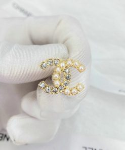 Gold pearl-encrusted Chanel logo ring.