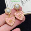 Elegant pink heart-shaped designer earrings with pearls.