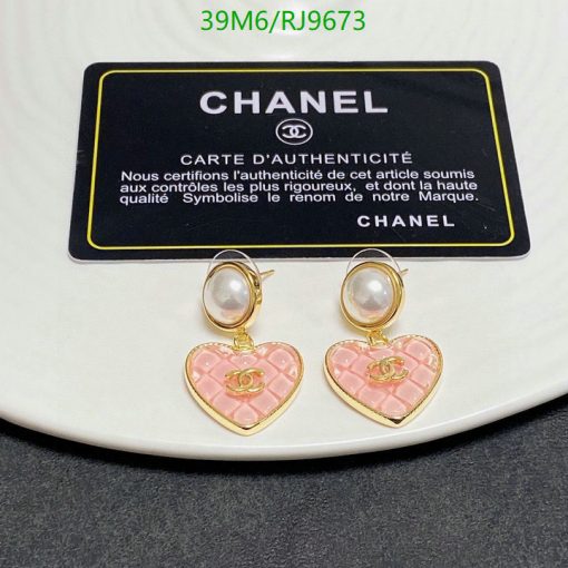 Pearl earrings with pink heart pendants and authenticity card.