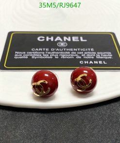 Chanel earrings and authenticity card on white surface.