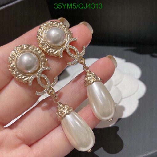 Elegant pearl drop earrings with gold accents.