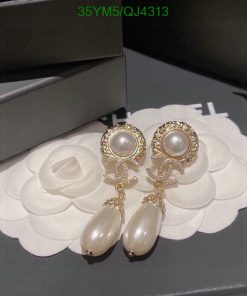 Elegant pearl drop earrings on white floral display.