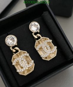 Elegant diamond gold earrings in a black box.