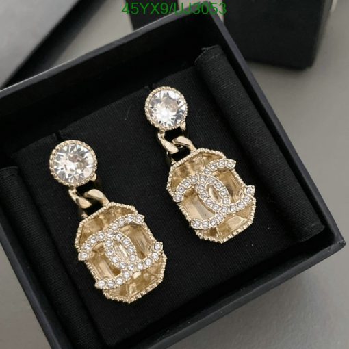 Elegant diamond gold earrings in a black box.