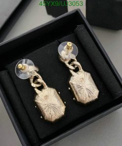 Gold dangle earrings in black box.