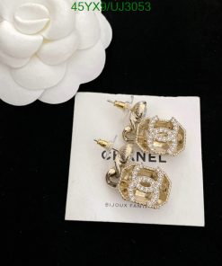 Elegant gold and rhinestone earrings on white display.