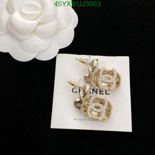 Elegant gold and rhinestone earrings on white display.