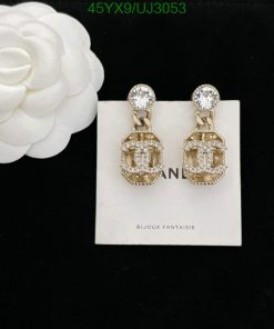 Elegant crystal-encrusted gold earrings with white flower.