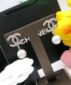 Designer logo earrings with pearl drop on display.