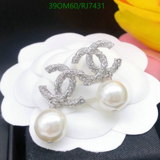 Elegant pearl earrings with diamond accents on white petal.