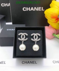 Designer logo earrings with pearls on display.